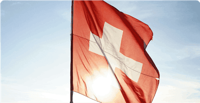 A banner showing a Swiss flag waving in the wind, accompanied by a text highlighting a 100% Swiss Cloud recognised for its reliability and standing throughout Europe.